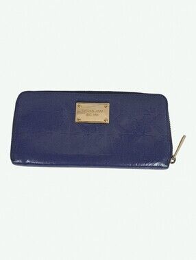 This is a blue Michael Kors continental ziparound wallet with a patent finish